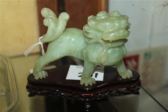 A Chinese bowenite jade figure of a lion-dog, 20th century, 11cm, wood stand